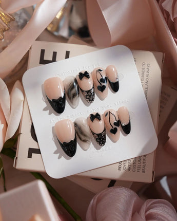 Dark Cherry handmade press-on nails featuring Chic Black & Nude, Lace Bows, Ink Marble Swirls & Glitter Heart Cherries.