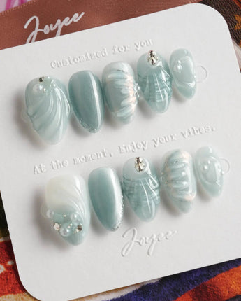 Dead Sea Blue press-on nails with Mediterranean seafoam shimmer and sculpted shell details