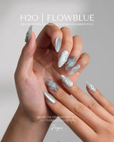 Dead Sea Blue medium almond nails with pearl accents and oceanic green glow