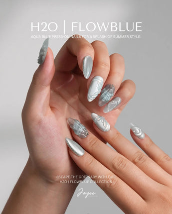 Dead Sea Blue medium almond nails with pearl accents and oceanic green glow