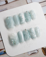 Dead Sea Blue in short coffin shape with seafoam shell and pearl nail art