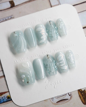 Dead Sea Blue in short coffin shape with seafoam shell and pearl nail art