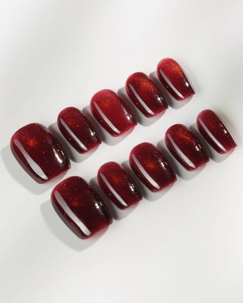 Deep Red Cat eye Nails press-on nails in extra short coffin shape — red cat eye christmas holiday