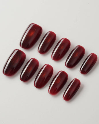 Deep Red Cat eye Nails press-on nails in medium oval shape — red cat eye christmas holiday