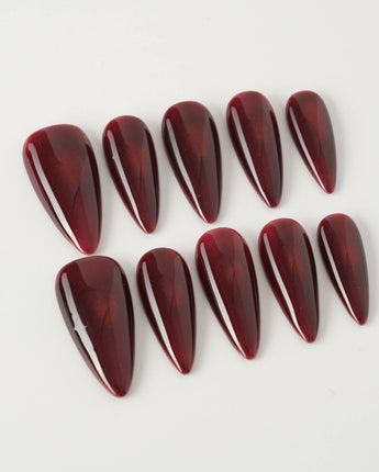 Deep Red Cat eye Nails press-on nails in medium stiletto shape — red cat eye christmas holiday