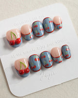 Denim Cherry Y2K press-on nails with playful cherries and blue denim-tip contrast