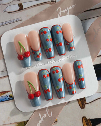 Denim Cherry close-up of red cherries popping over blue denim-textured gel nails
