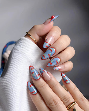 Denim Cherry Y2K nails with nude base, denim blue tips, and hand-painted cherry accents