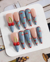 Denim Cherry festival nails with red outlined tips and bold cherry-over-denim details
