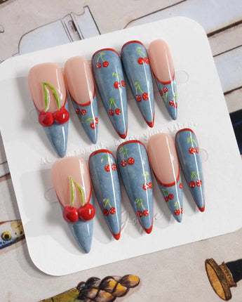 Denim Cherry festival nails with red outlined tips and bold cherry-over-denim details