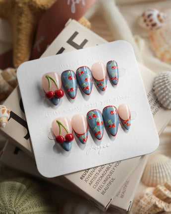 Denim Cherry short stiletto nails with denim texture, red outlines, and cherry details