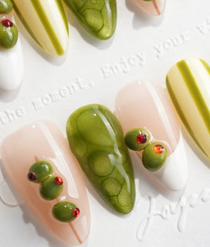Dirty Martini cocktail-inspired nails with red pimento olive accents and nude gel