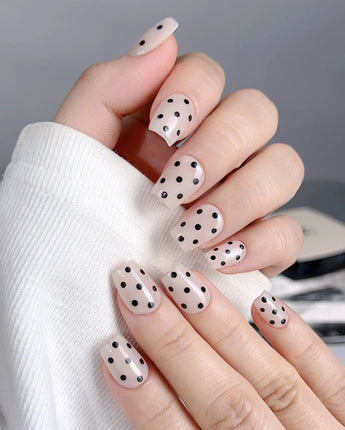 Dot Noir-Mini nail set with nude and black contrast plus playful retro polka dots