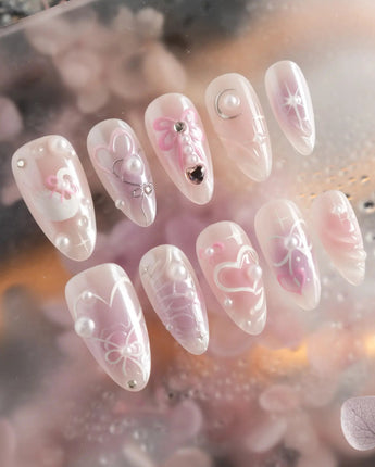 Dreamglow handmade press-on nails featuring Pearly Pink, 3D Bows & Pearls.