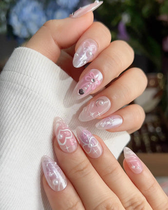 Dreamglow storybook nails with soft sky mood, pink gel, bows, and pearls