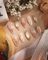 Dreamland Glow press-on nails with sculpted gold butterfly accents and dreamy bridal nail art