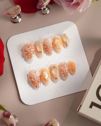 Dreamland Glow press-on nails with gold sculpted butterflies and luminous fall nail art