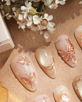 Dreamland Glow press-on nails with dreamy gold 3D butterflies and delicate bridal accents