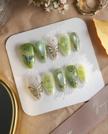 Dreamland handmade butterfly nails with forest green shimmer and chrome accents