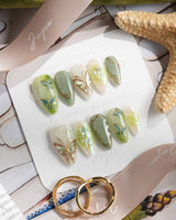 Dreamland short almond press-on nails with sage green cat-eye and gold butterfly vines