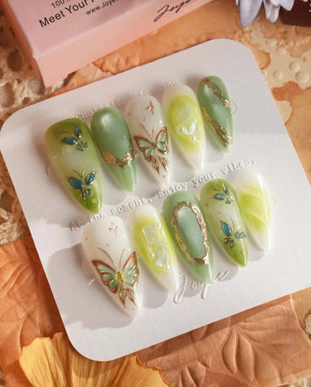 Dreamland short almond nail art with two-toned butterfly and chrome linework