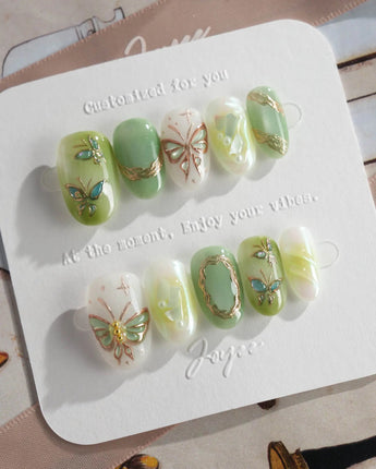 Dreamland green butterfly press-on nails with luminous cat-eye gel finish