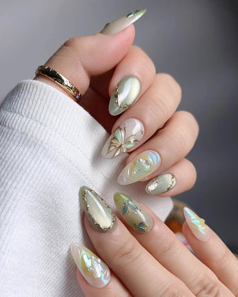 Dreamland close-up of layered green butterfly wings and vine nail art