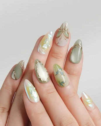 Dreamland green cat-eye nail set with chrome lines and 3D gold butterfly