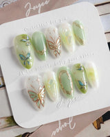Dreamland glossy butterfly nail art with sage green cat-eye depth