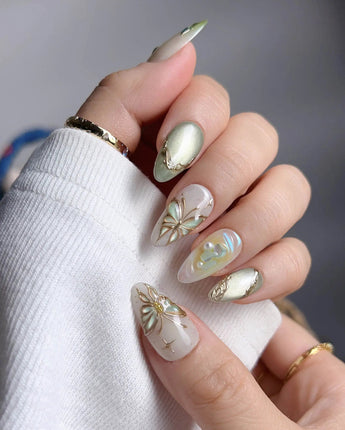 Dreamland glossy green press-on nails with layered butterfly wing glow