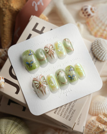 Dreamland short square press-on nails with green cat-eye and gold butterfly vines