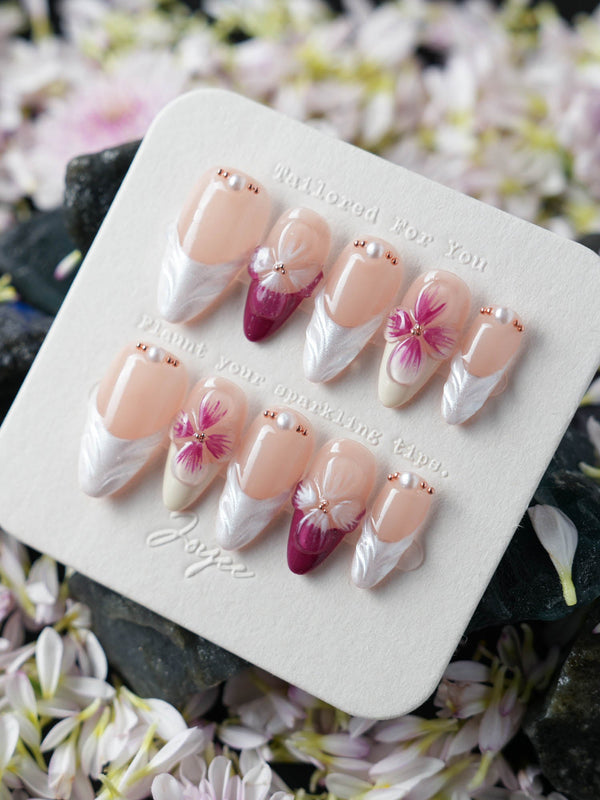 Handcrafted purple press-on nails with 3D flower accents