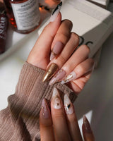 Egyptian Gold handmade press-on nails with black-and-gold detailing on nude base