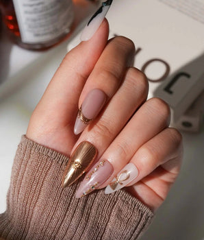 Egyptian Gold S press-on nails in medium stiletto with scarab and Eye of Horus details