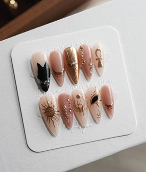 Egyptian Gold XS press-on nails in medium stiletto with 3D gold sun and ankh