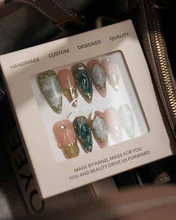 Electric Muse handmade press-on nails featuring emerald green cat eye marble gold frame nude base 3D sculpted glossy