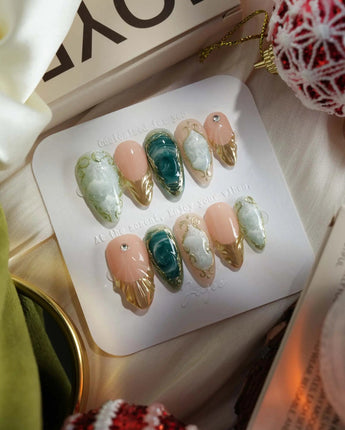 Electric Muse press-on nails with frosted blue-green marble, nude base and metallic gold details
