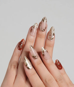 Falling leaves press-on nails with caramel fall colors, raised gold leaf reliefs and vine accents