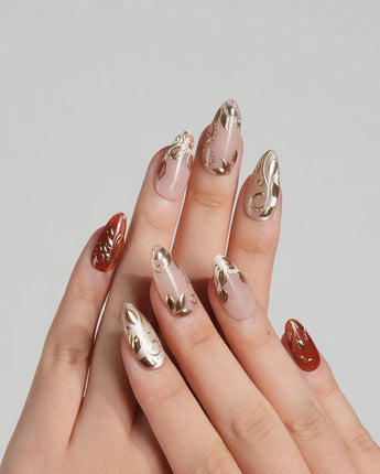 Falling leaves press-on nails with caramel fall colors, raised gold leaf reliefs and vine accents
