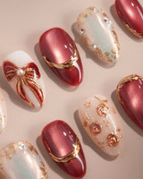 Coquette Red press-on nails with elegant red floral accents, gold outlines and glossy nude base