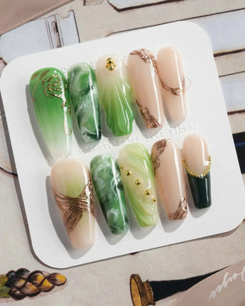 Emerald - Jade Sutra press-on nails in long coffin shape — Elegant Grape Green, Marble Smudge & Liquid Metal.