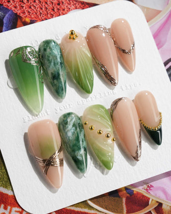 Emerald - Jade Sutra press-on nails in medium stiletto shape — Elegant Grape Green, Marble Smudge & Liquid Metal.