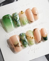Emerald - Jade Sutra press-on nails in short coffin shape — Elegant Grape Green, Marble Smudge & Liquid Metal.