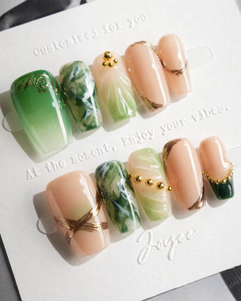 Emerald - Jade Sutra press-on nails in short coffin shape — Elegant Grape Green, Marble Smudge & Liquid Metal.