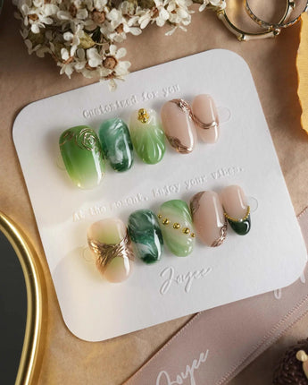 Emerald - Jade Sutra press-on nails in short oval shape — Elegant Grape Green, Marble Smudge & Liquid Metal.