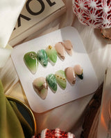 Emerald - Jade Sutra press-on nails in short stiletto shape — Elegant Grape Green, Marble Smudge & Liquid Metal.