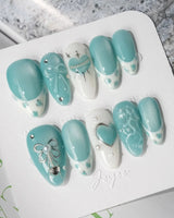 Exuma Blue sweetcore nails with turquoise jelly base, pearls, and icy rhinestone shine