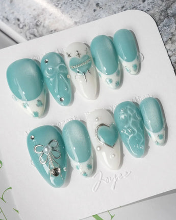 Exuma Blue sweetcore nails with turquoise jelly base, pearls, and icy rhinestone shine