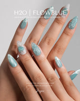 Exuma Blue short almond press-ons with Caribbean blue sparkle and playful 3D accents