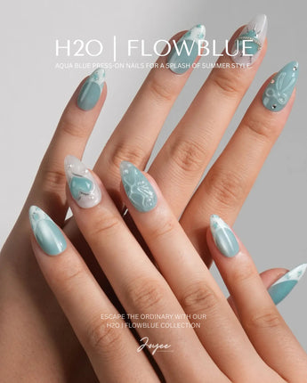 Exuma Blue short almond press-ons with Caribbean blue sparkle and playful 3D accents